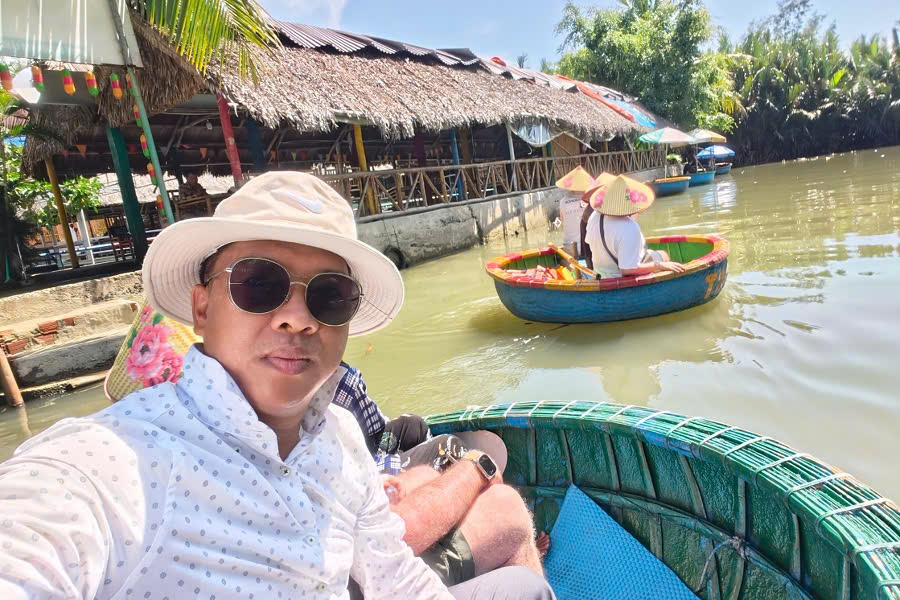 Mr. Viet Nguyen enjoying a bamboo basket boat ride in Cam Thanh Coconut Village during the best Central Vietnam tour