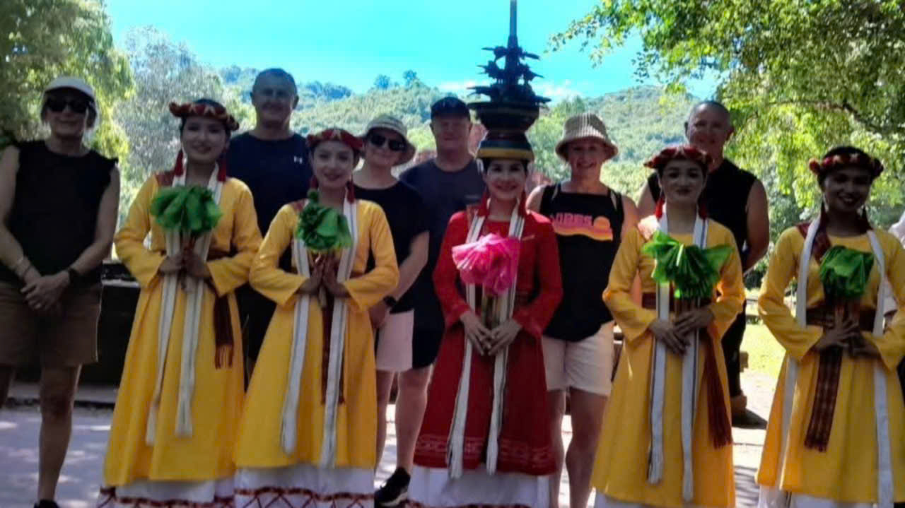 Guests taking a photo with Cham dancers at Group G in My Son Sanctuary during a cultural performance