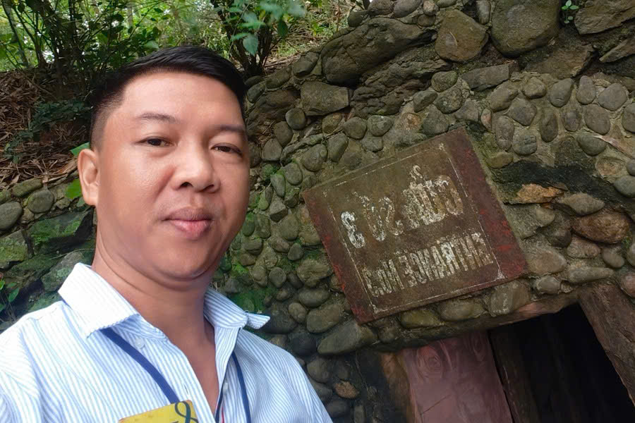 Mr. Viet Nguyen at the entrance of Vinh Moc Tunnels during a Multi-Day Vietnam Tour