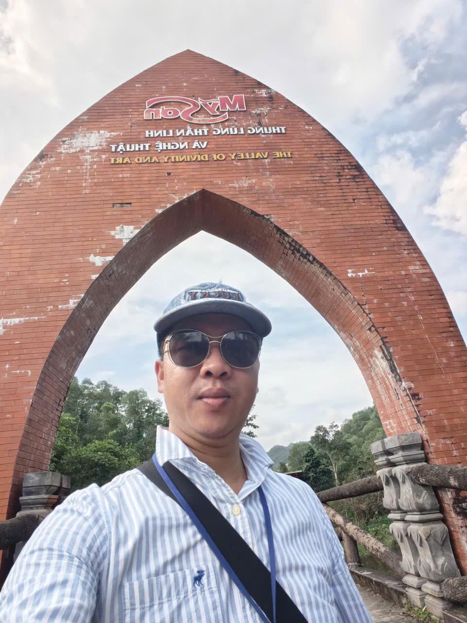 our guide Viet Nguyen taking a selfie at the entrance gate of My Son Sanctuary ancient Cham temple site