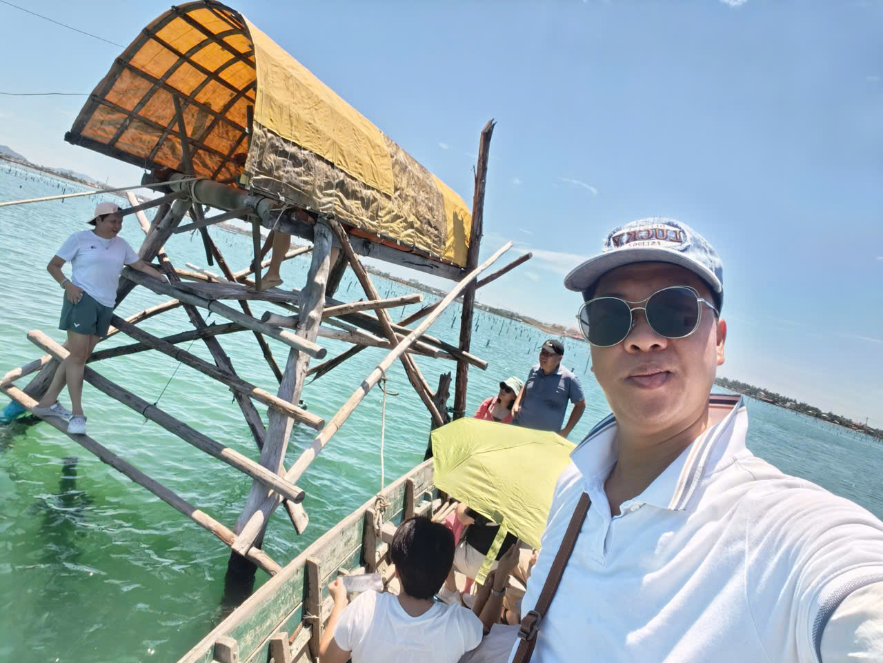 Viet Nguyen posing with guests at the scenic Lap An Lagoon near Lang Co Bay in Central Vietnam.