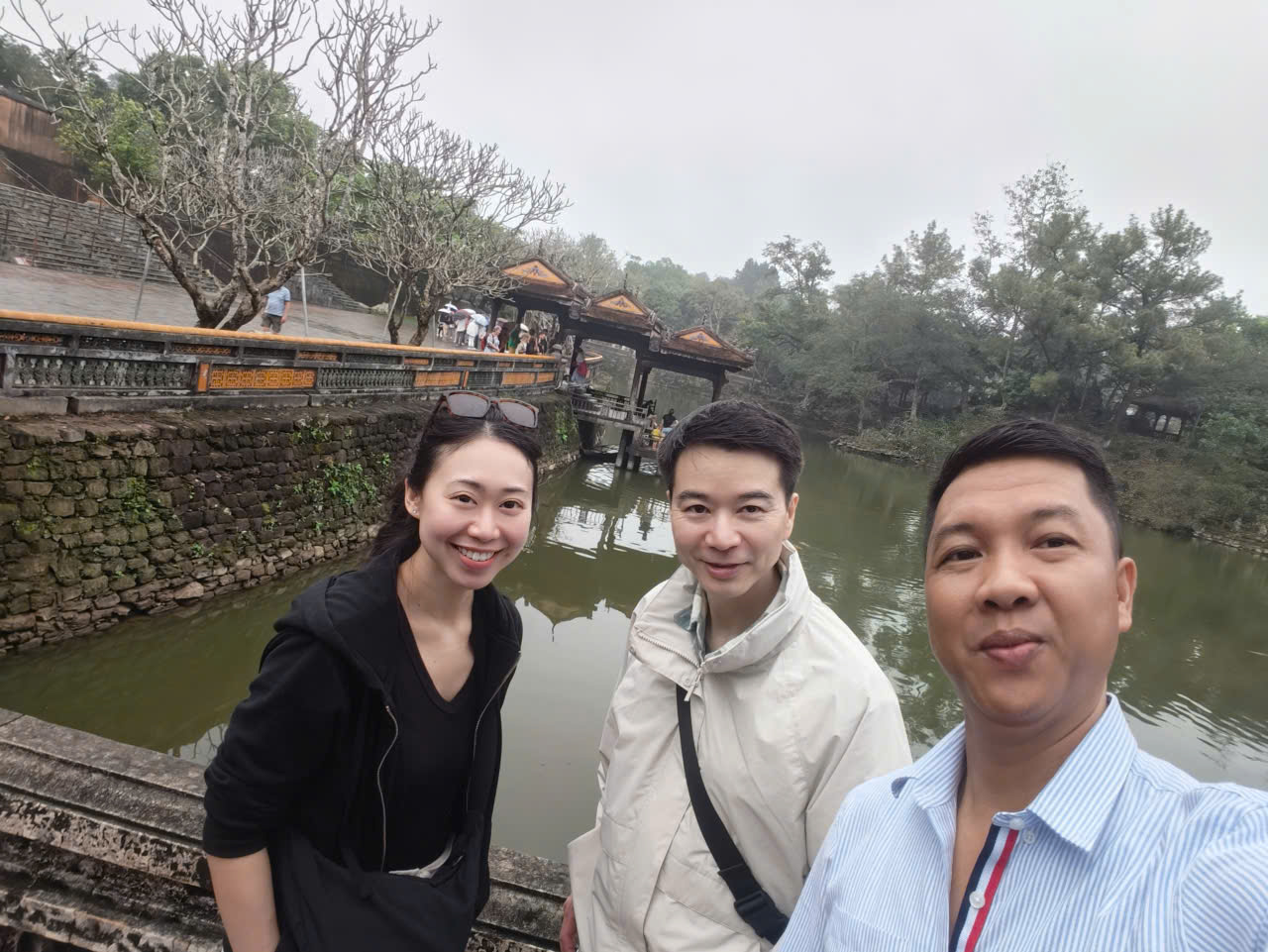 Viet Nguyen taking a selfie with guests at Tu Duc Tomb during a Hue city tour from da nang.