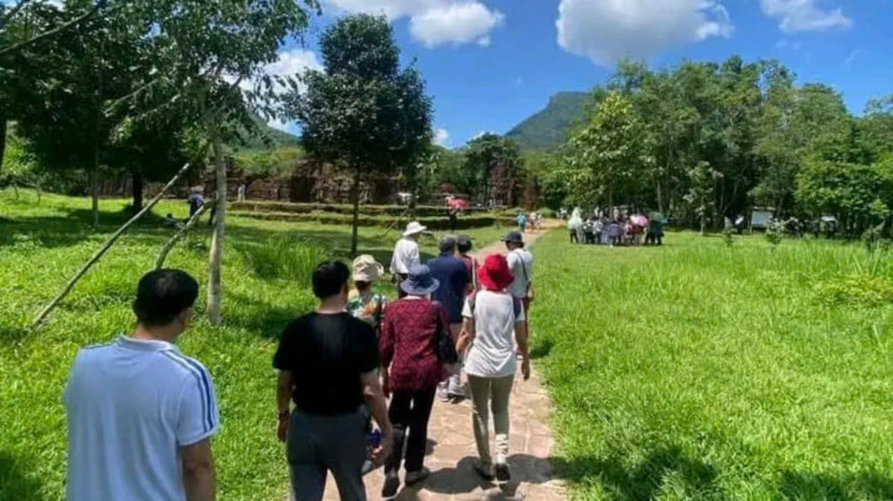 Guests walking along the pathway toward the ancient temples of My Son Sanctuary in Central Vietnam