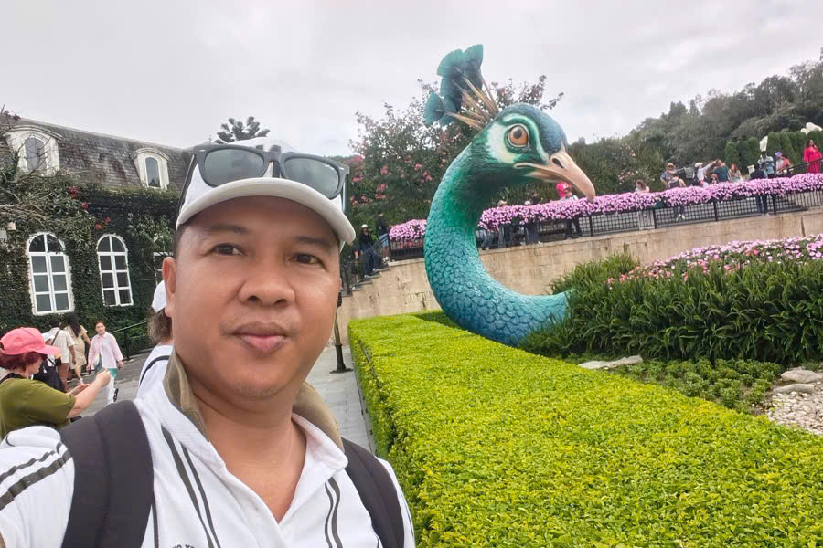 Viet Nguyen takes a selfie at La Jardin D'Amour Flower Garden in Ba Na Hills