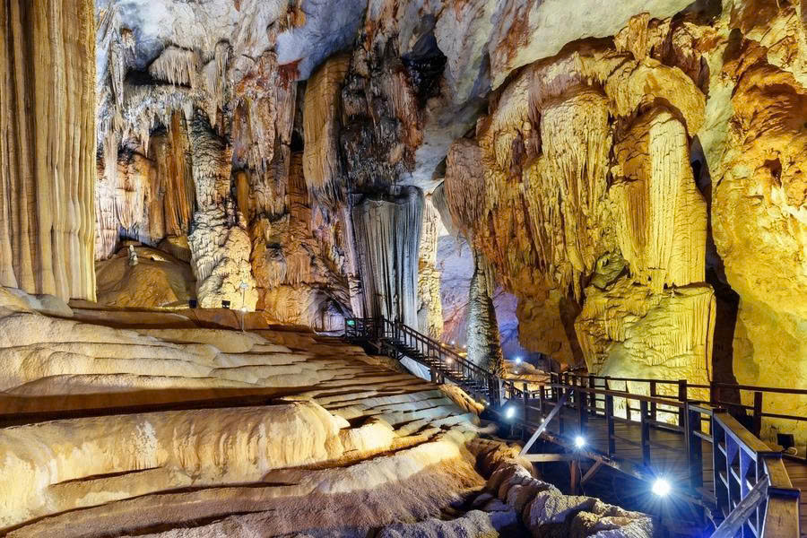 Wooden walkway through the limestone chambers of Paradise Cave in Vietnam