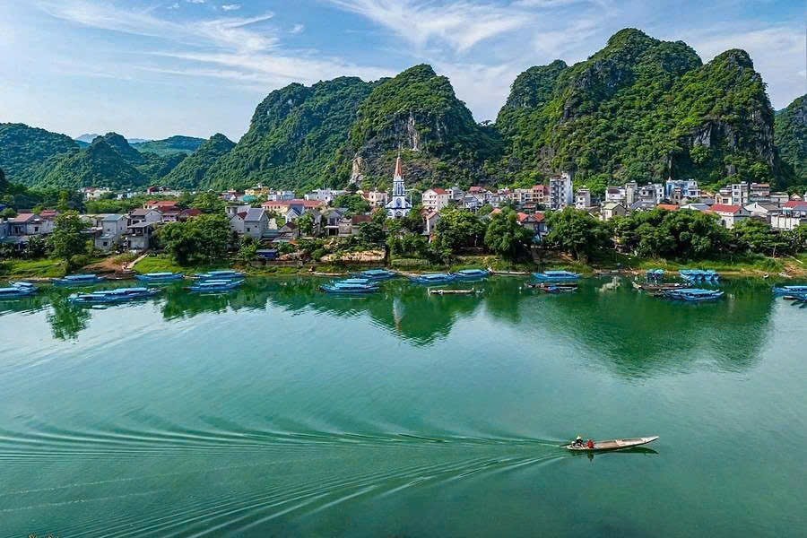 Rural village and green countryside beside the Son River in Phong Nha